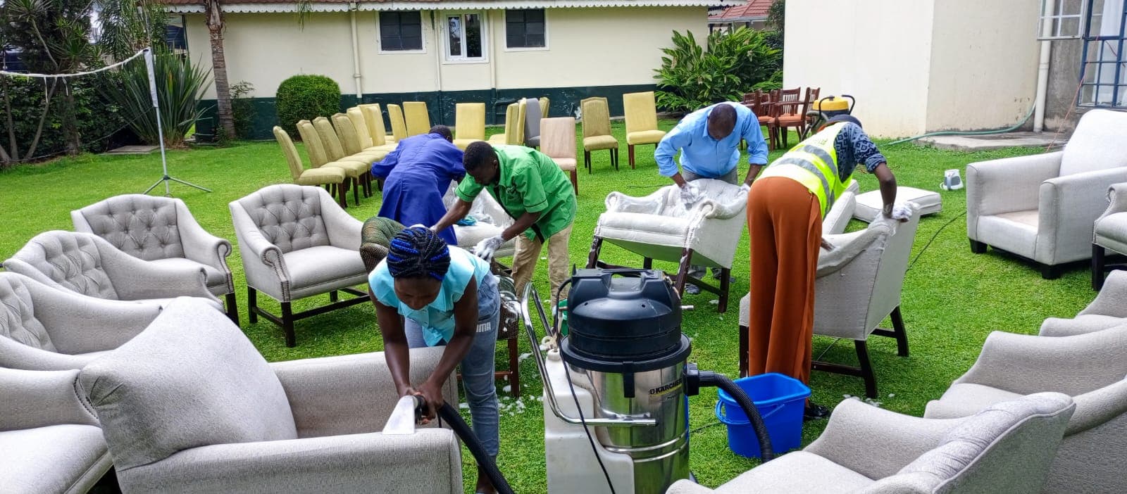 Twin Brothers team steam-cleaning a full set of sofas and dining chairs on site in Nakuru